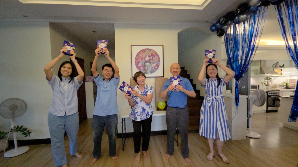 Family members happily holding up their Choco Mucho snack prize packs
